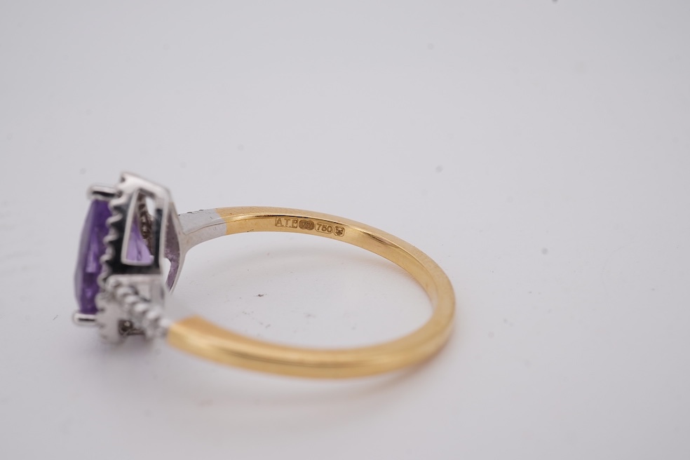 A modern 18ct gold and single stone pear cut amethyst set ring, with diamond chip set border and shoulders, size O, gross weight 3.4 grams. Condition - fair to good
